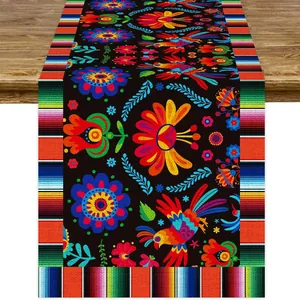 Detalle de camino de mesa mexicano vibrante con flores, aves y rayas estilo Serape.