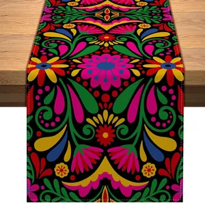 Colorful Mexican Day of the Dead floral print table runner on a natural wooden surface