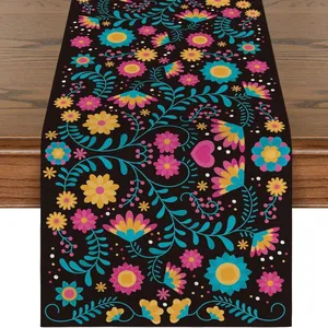Close-up detail of Mexican Day of the Dead floral linen table runner with vibrant pattern.