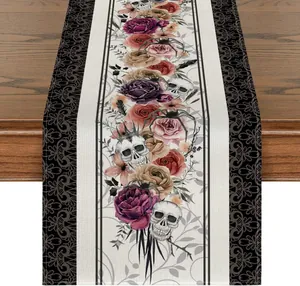 Detail of Halloween table runner featuring floral roses, skulls and spider print pattern.