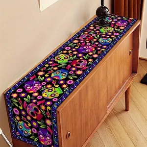 Detailed view of Day of the Dead table runner with colorful skull patterns on wood cabinet