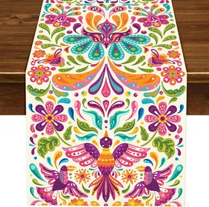 Close-up of colorful Mexican fiesta table runner with bird and floral folk art patterns.
