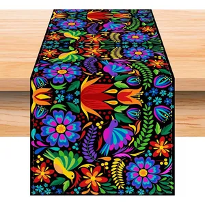 Vibrant Mexican carnival table runner with colorful Otomi floral and bird patterns on wood.