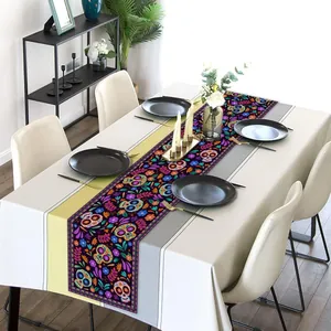 Day of the Dead table runner with colorful skull and flower prints on linen cloth