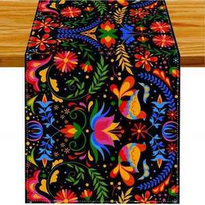Mexican Day of the Dead table runner with colorful floral and bird patterns on black.