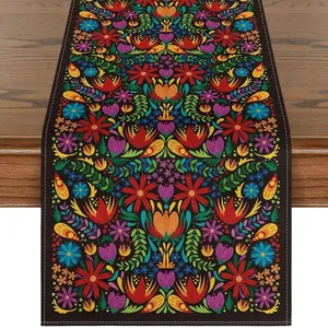 Detailed macro view of vibrant Mexican floral pattern on black linen table runner decor