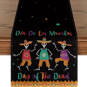 Detailed print of Day of the Dead skeletons on a black linen table runner