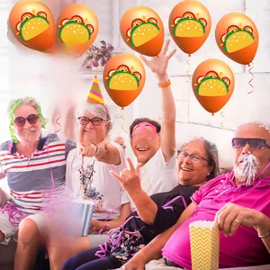 Festive orange Cinco de Mayo balloons featuring taco prints shown in a joyful party setting