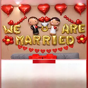 Wedding decoration set featuring red heart balloons and gold We Are Married letters.