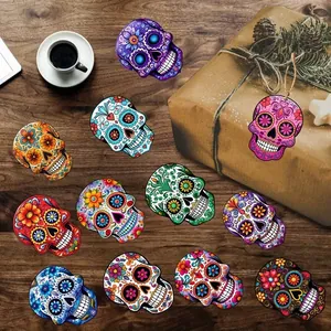 Collection of colorful wooden sugar skull ornaments for Day of the Dead party decoration.