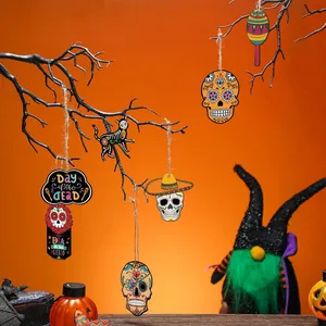 Mexican Day of the Dead wooden hanging ornaments displayed on decorative black branches