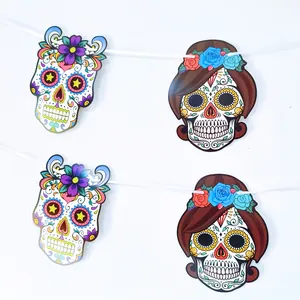 Detail view of colorful Mexican Day of the Dead sugar skull paper bunting on white string