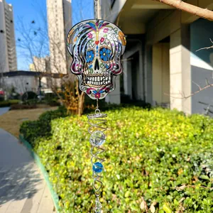 3D sugar skull wind spinner made of stainless steel with a crystal spiral tail for garden decor.