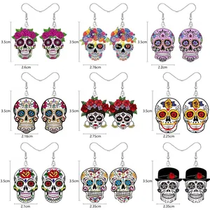Close-up of nine pairs of Day of the Dead style acrylic skull earrings with measurements