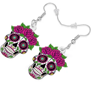 Detailed view of acrylic sugar skull earrings with vibrant red rose flower patterns.