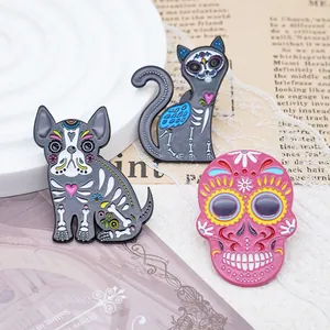 Detailed view of Halloween skull, dog, and cat enamel pins with Mexican Day of the Dead patterns