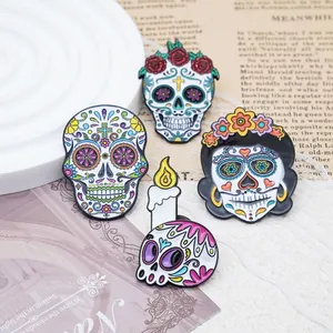 Detail view of colorful Mexican sugar skull enamel pins for Day of the Dead jewelry