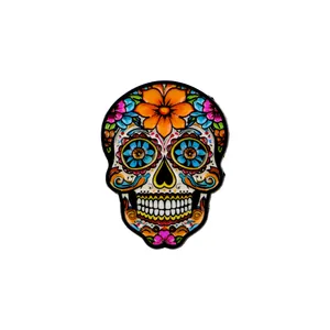 Colorful Mexican sugar skull enamel pin with vibrant floral patterns on white background.