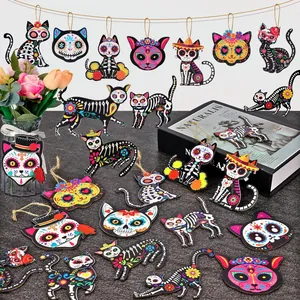 Colorful wooden Day of the Dead cat ornaments with vibrant skull prints and strings