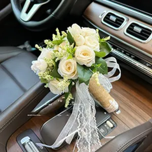 Detailed view of elegant white artificial rose bouquet with lace ribbon inside a car