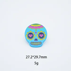 Detail view of Mexican style skull enamel pin showing 27.2x29.7mm size and 5g weight