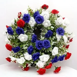 Detailed view of an artificial flower wreath featuring red white and blue roses for decor