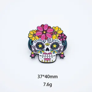 Detailed view of colorful Mexican sugar skull enamel pin with flower decorations