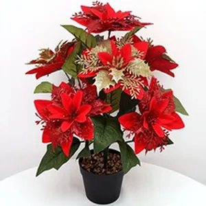 Realistic artificial red and gold poinsettia plant in black pot for Christmas home decor.