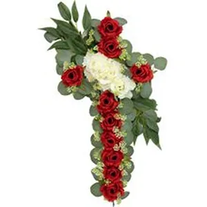 Detailed view of artificial red and white flower arrangement in a cross shape for wall decor