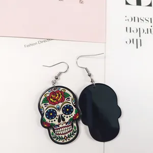 Vue détaillée de boucles d'oreilles tête de mort colorées, recto et verso
