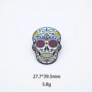 Detailed close-up of vibrant Mexican sugar skull enamel pin with floral patterns