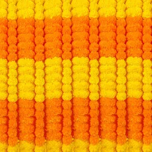 Detailed macro view of vibrant yellow and orange artificial marigold flower garlands