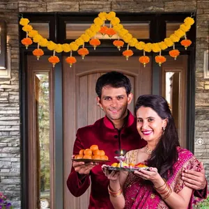 Traditional yellow and orange marigold flower garland hung over a home entryway door