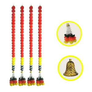 Detail view of four artificial marigold flower garlands with golden bells for festivals