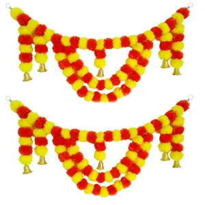 Detailed view of yellow and orange artificial marigold garlands with golden bells.