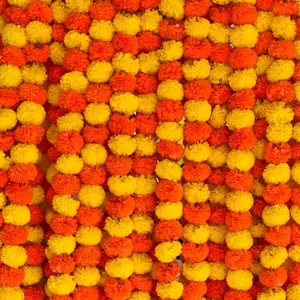 Dense vertical rows of vibrant orange and yellow marigold garlands for festival decor