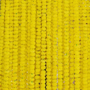 Detailed view of vibrant yellow artificial marigold flower garlands for festive decor