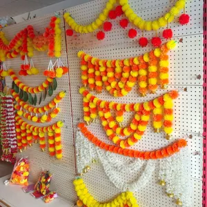 Vibrant marigold garlands with gold bells for Indian wedding and festival decor