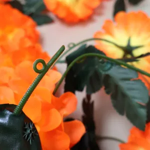 Detailed macro view showing the realistic texture of artificial orange marigold vine