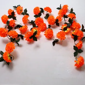 Vibrant orange marigold garland detail for Day of the Dead and festive wall decor