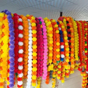 Detailed view of vibrant artificial marigold garlands in multiple color combinations