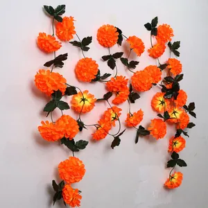 Close-up detail of vibrant orange artificial marigold garland for festival decor