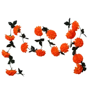 Detailed view of orange artificial marigold garland for Day of the Dead decoration.