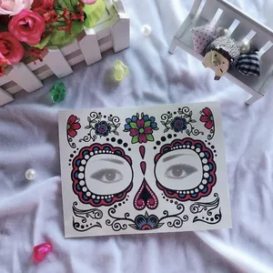 Close-up of Halloween Day of the Dead face tattoo stickers with floral sugar skull design.