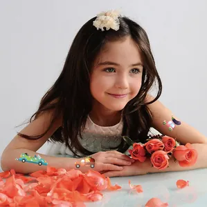High-quality close-up of colorful cartoon car temporary tattoos on a young girl's arm
