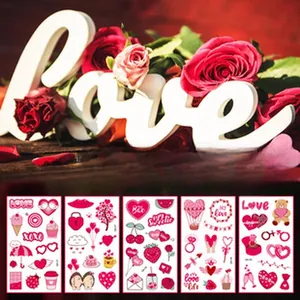 Detail view of Valentine's Day temporary tattoo stickers with pink hearts and floral patterns