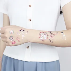 Luminous Day of the Dead temporary tattoos for kids with cartoon skull designs on arm