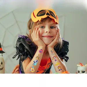 Close-up view of colorful Day of the Dead temporary tattoos applied on child's arms
