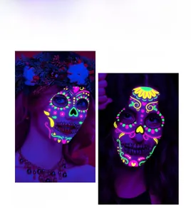 Close-up of neon fluorescent face tattoos for Day of the Dead and Halloween party.
