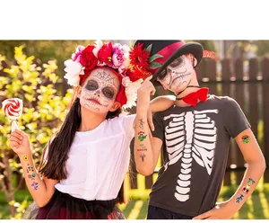 Two children showing colorful Day of the Dead temporary tattoos for Halloween celebration